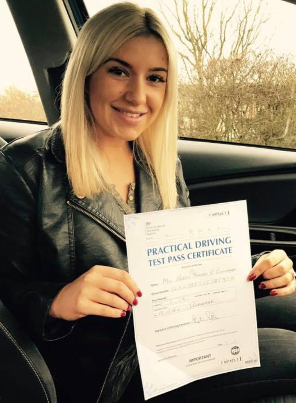 this woman learned to drive in dunfermline with your pass driving school, a happy look on her face with her pass certificate.